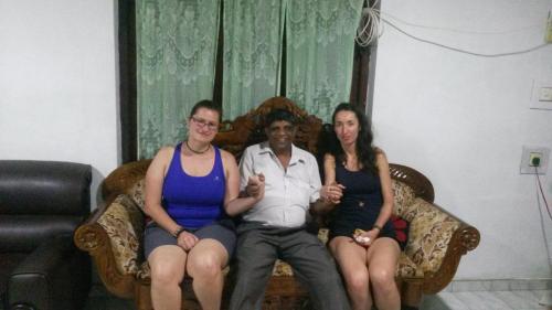 a group of three people sitting on a couch at Peacock Residence & Cabana's in Tangalle