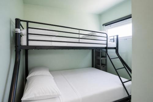 a bunk bed with a ladder and a white pillow at Wonderful chalet in De Haan in De Haan