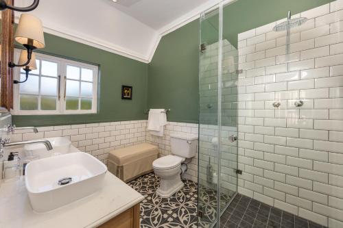 a bathroom with a toilet and a sink and a shower at The Claremont Boutique Hotel in Cape Town