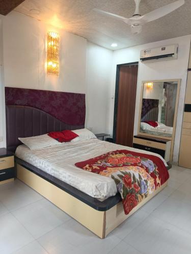 a bedroom with a large bed with a mirror at Jannat Villa by Book Ur Stay in Lonavala