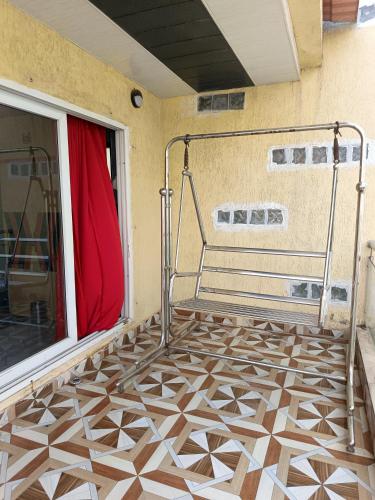 a room with a balcony with a tile floor at Jannat Villa by Book Ur Stay in Lonavala