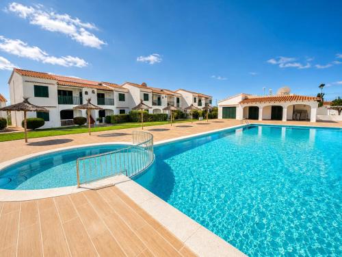 a swimming pool in front of a villa at Cala Porter Brise Marine in Cala en Porter