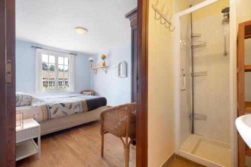 a bedroom with a bed and a shower at Gite La Forge in Le Buisson de Cadouin
