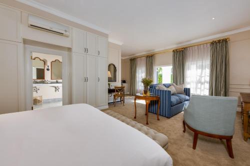 a bedroom with a bed and a living room at The Claremont Boutique Hotel in Cape Town