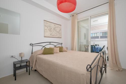 a bedroom with a bed and a red lamp at Casa vacanze vento di mare in Alghero