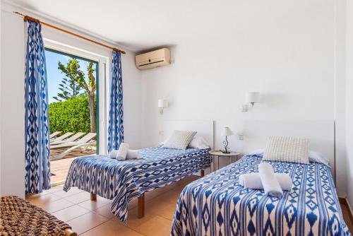 a bedroom with two beds and a balcony at Villa Ana by Escape Home in Santo Tomás