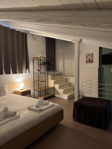 a bedroom with a bed and a staircase in the background at Antico castello BeB in Altamura