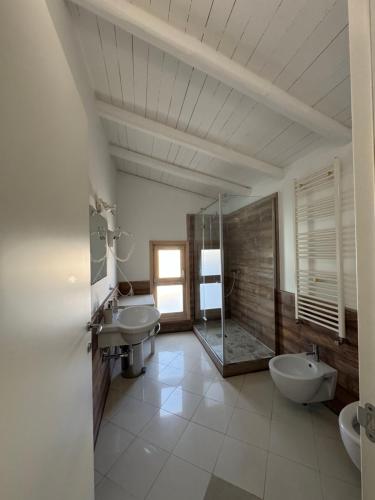 a bathroom with two sinks and a shower at Antico castello BeB in Altamura