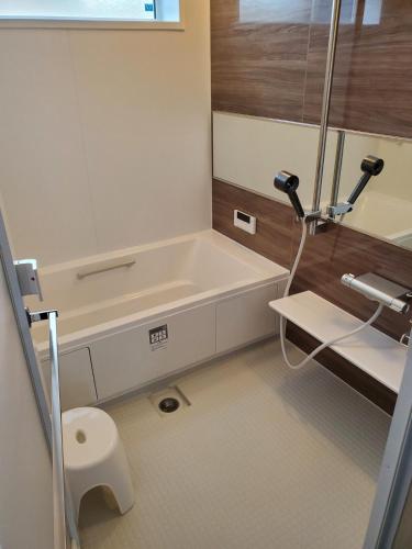 a bathroom with a bath tub and a sink at 鉾田の家 in Hokota