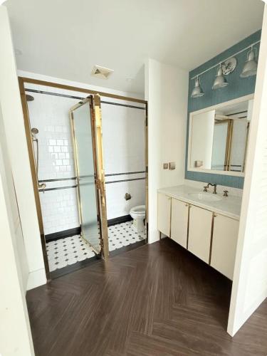 a bathroom with a shower and a toilet and a sink at Pattaya Private Beach - Grand Florida Beachfront Condo Resort in Na Jomtien
