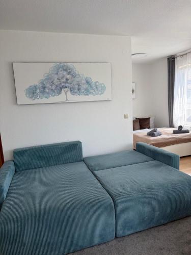 a bedroom with a blue couch and a bed at Sonnenoase in Sigmaringen in Sigmaringen