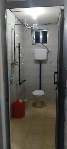 a bathroom with a toilet in a room at Antique Lodge in Arusha