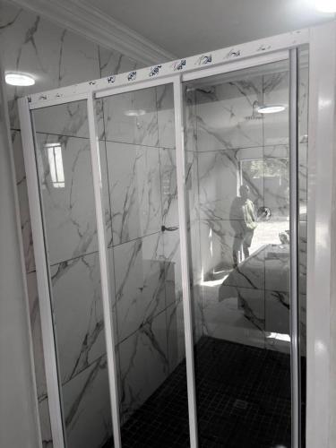 a man standing in a room with a marble wall at Fullmoon Homes 9A in Edenvale