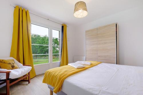 a bedroom with a bed and a window with yellow curtains at Gite de l'Egal in Le Buisson de Cadouin