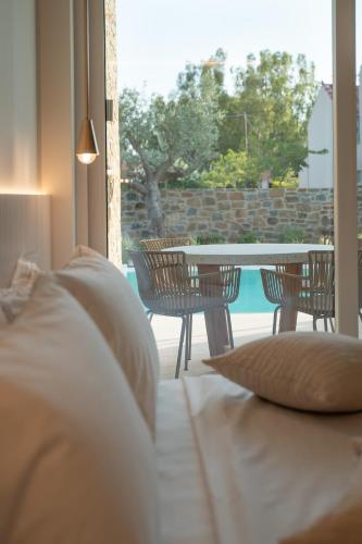 a bedroom with a table and chairs and a patio at Gialova Hills 8 in Gialova
