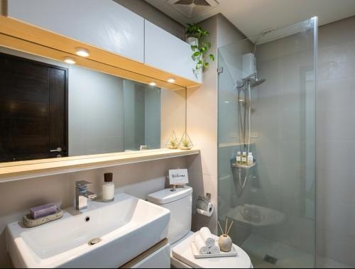 a bathroom with a sink and a glass shower at Midtown Cebu City Condo in Cebu City