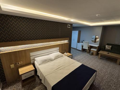 a hotel room with a bed and a desk at Grand Ali'n Tokat in Tokat