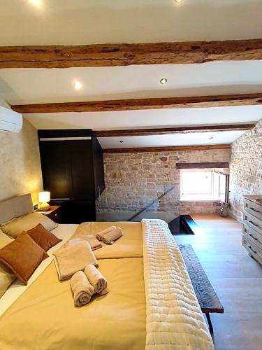 a bedroom with a large bed with two towels on it at Casa Eddy in Bale