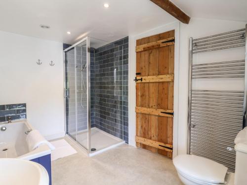 a bathroom with a shower and a toilet and a sink at Harbins Farm in Sherborne