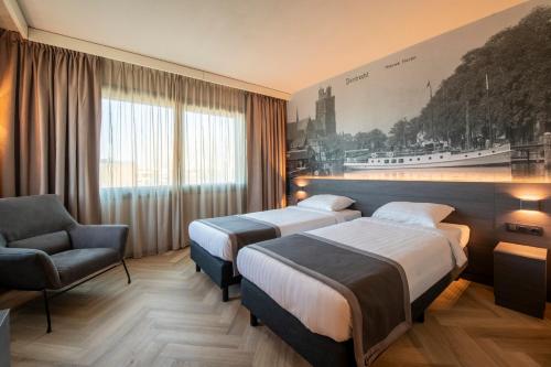a hotel room with two beds and a chair at Bastion Hotel Dordrecht Papendrecht in Dordrecht