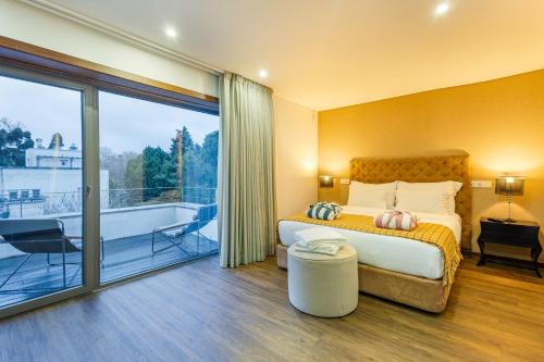 a bedroom with a bed and a balcony at Luxury by ON Apartments in Porto