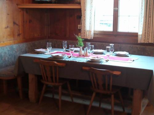 a table with glasses and plates on it in a room at Schwaighof in Oberau