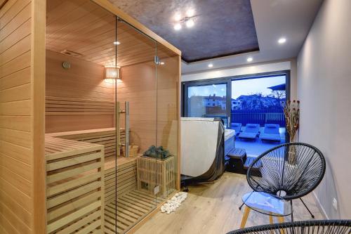 a sauna with a bench and a chair in a room at Villa Orion - Private Heated Pool, Sauna & Jacuzzi in Rovinj