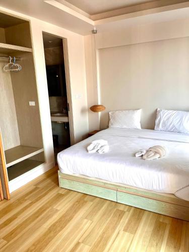 a bedroom with a bed with two towels on it at Coconut Suite Aonang in Ao Nang Beach