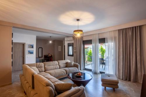 a living room with a couch and a table at Old Square House in Pefkochori