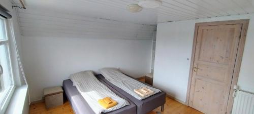 a small room with a bed and a door at M1 Stay in Bevtoft