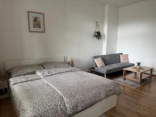 a bedroom with a bed and a chair at StayU Apartment in Ústí nad Labem