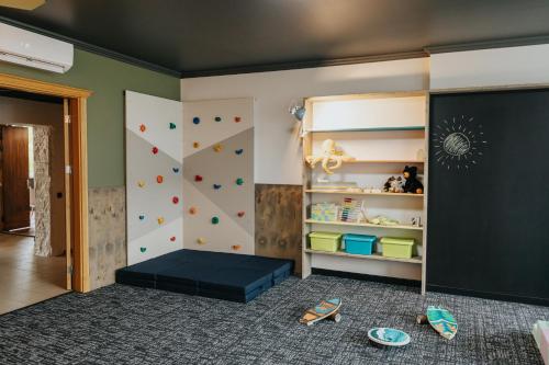 a childs room with a rock climbing wall at KVARC Hotel in Valmiermuiža