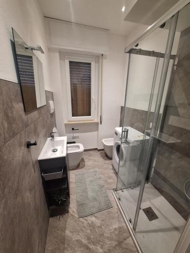 a bathroom with a shower and a toilet and a sink at Mamma Lucia accommodation in Borno