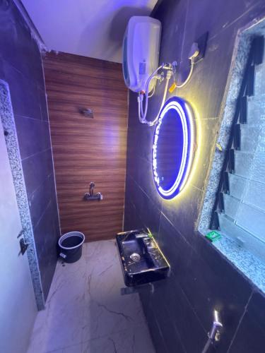 a bathroom with a round mirror and a sink at Avera luxurious stay in Igatpuri