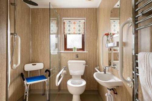 a bathroom with a toilet and a sink at L23 Cormorant in Truro