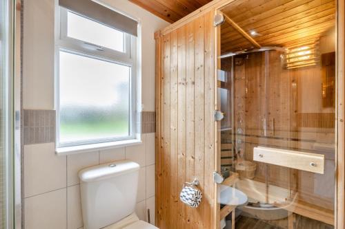 a bathroom with a toilet and a window at Field View 2 bed 'S'- Sycamore in Eye