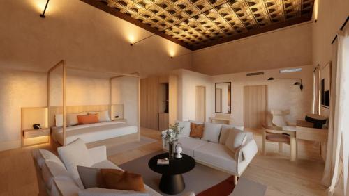 a living room with a couch and a bed at Castilla Termal Palacio de Avellaneda in Peñaranda de Duero