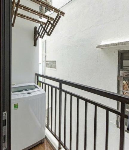 a laundry room with a washer and dryer on a balcony at Seasol Beach Boutique hotel in Danang