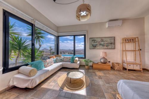 a living room with a couch and a table at Villa El Erizo - Pool By Lanzarote Vacation Homes in Nazaret