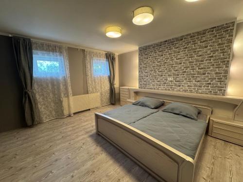 a bedroom with a bed and a brick wall at Ferienwohnung Mimi in Wernigerode