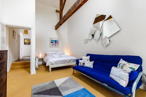 a living room with a blue couch and a bed at 2 Bed in Embleton oc-nb1960 in Embleton