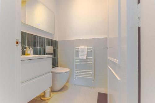 a white bathroom with a toilet and a shower at 2 Bed in Embleton oc-nb1960 in Embleton