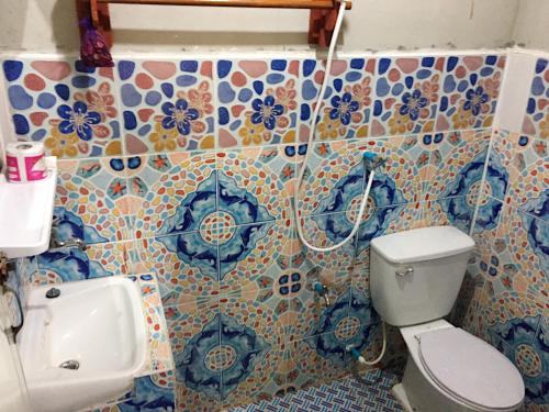 a bathroom with a toilet and a sink at Hutyee Boat Bungalow in Ko Lanta