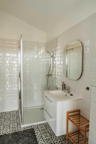 a bathroom with a shower and a sink and a mirror at Faház- Naplemente in Véménd