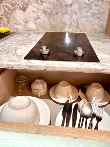 a kitchen with a sink and plates and utensils at Coconut Condo Aonang in Ao Nang Beach