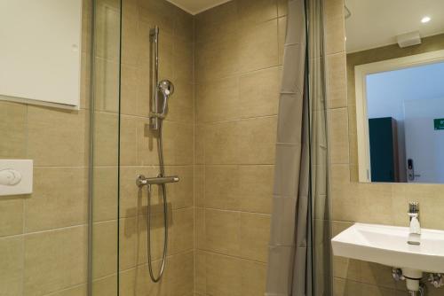 a bathroom with a shower and a sink at Easy Stay Næstved in Næstved