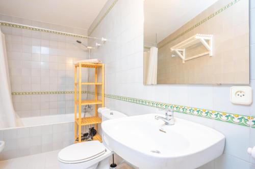 a bathroom with a sink and a toilet and a mirror at Can Romaguera in Algaida