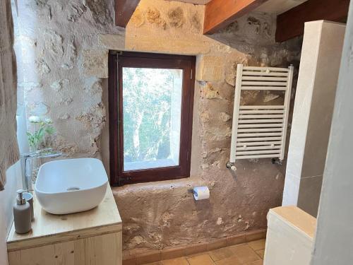 a bathroom with a sink and a window at Can Pina - Eco Pina - in Costitx
