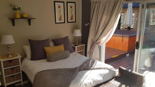 a bedroom with a bed and a sliding glass door at Junior Suite with Pool View - in Port Elizabeth