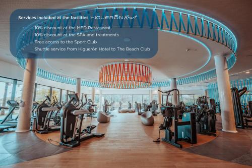 a gym in a hotel with treadmills and ellipticals at Higuerón Rental Marítimo Romar C - Managed by Higuerón Resort in Fuengirola